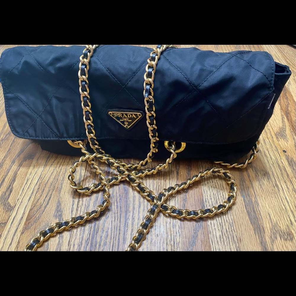 Black Prada nylon shoulder bag with gold chain.